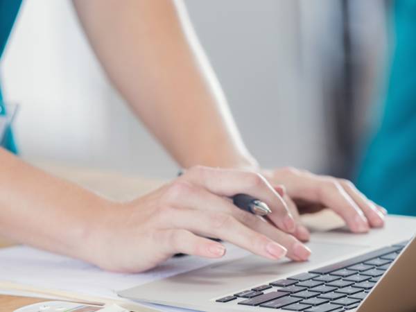Nurse typing on computer