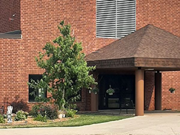 Front Entrance Maplewood Residential Building brown brick exterior with tree