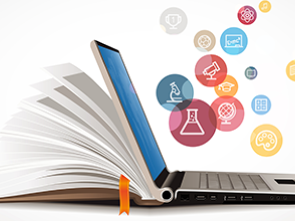 An open laptop and book with floating bubbles that have medical-based icons in them