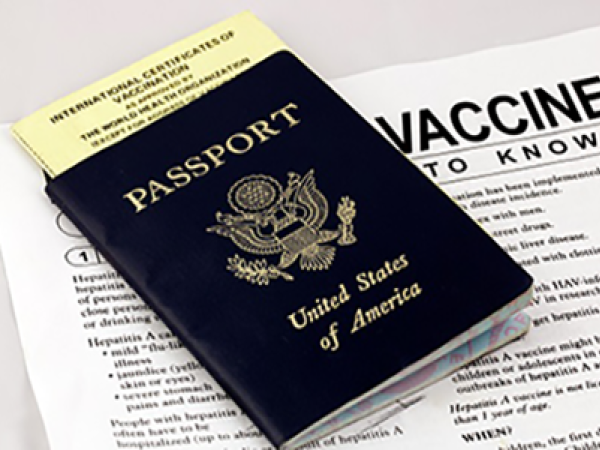U.S. passport atop vaccine paperwork