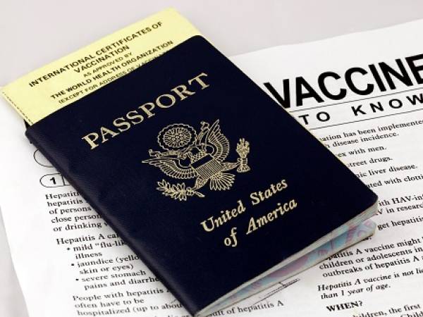 U.S. passport atop vaccine paperwork