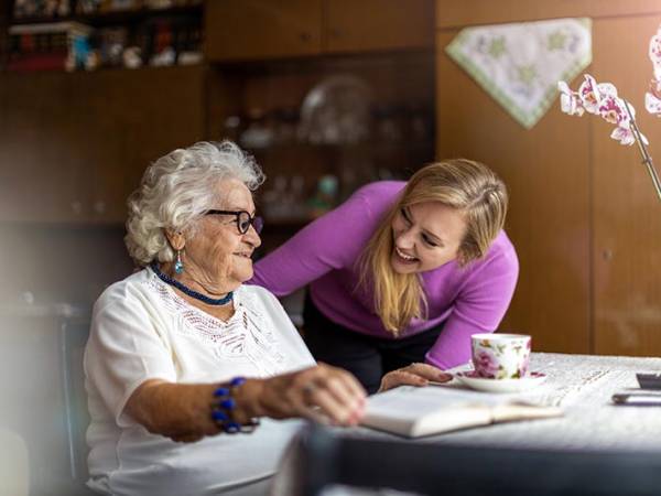 older-woman-sitting-with-caregiver