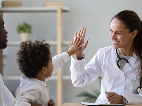 child high fiving medical provider