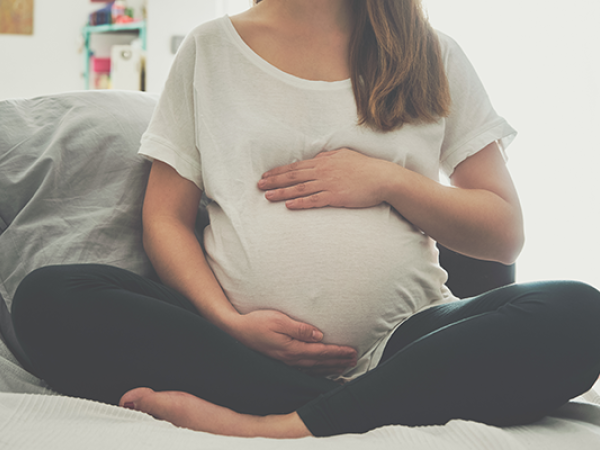 Pregnant woman holding belly