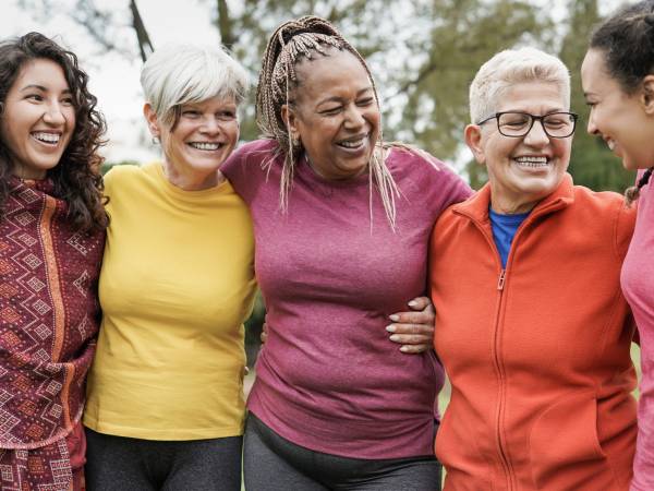 Women standing together smiling