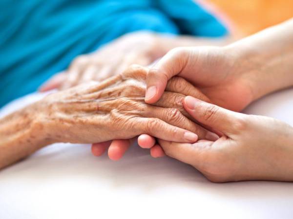 Young hands holding older hands