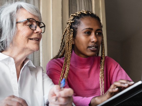 two women looking at a laptop together