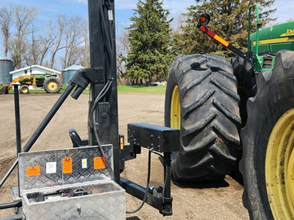 A John Deere tractor with a power lift attached.