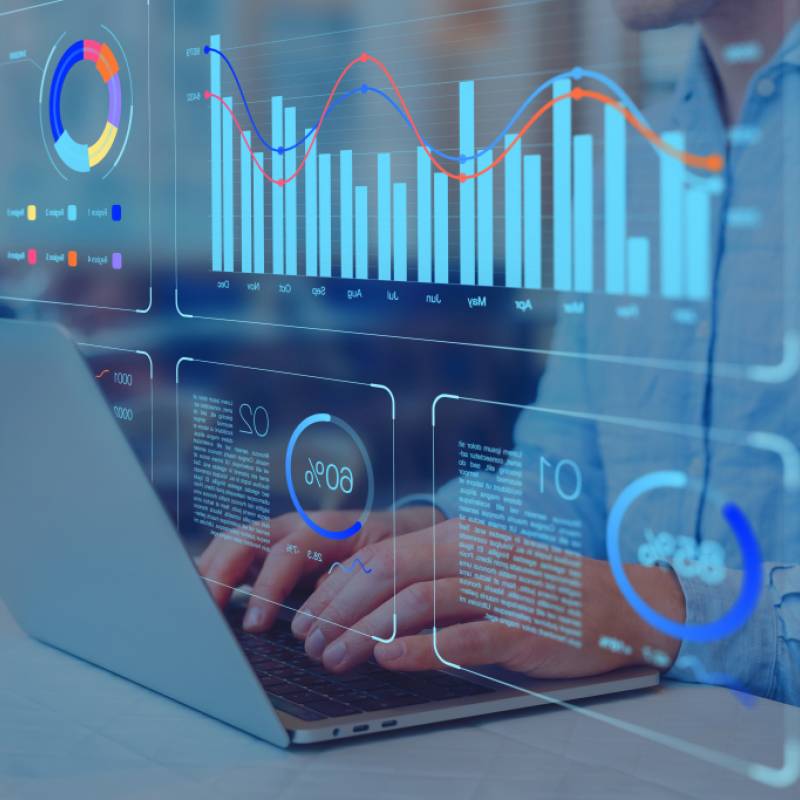person typing on a laptop working with data charts dashboards