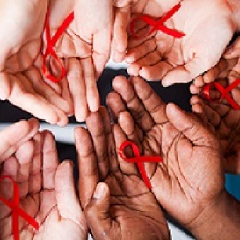 In a circle, five pairs of hands palm up with red ribbon