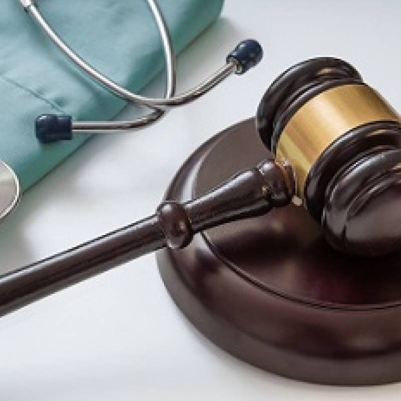 Gavel with scrubs and stethoscope