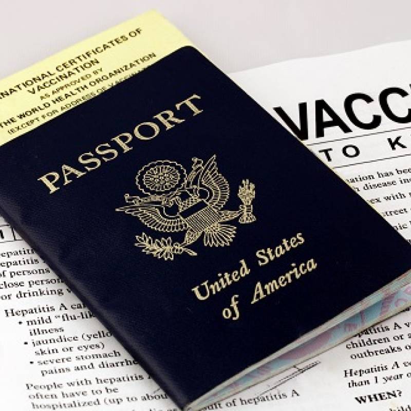 U.S. passport atop vaccine paperwork