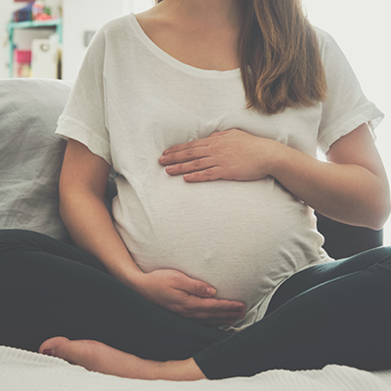 Pregnant woman holding belly