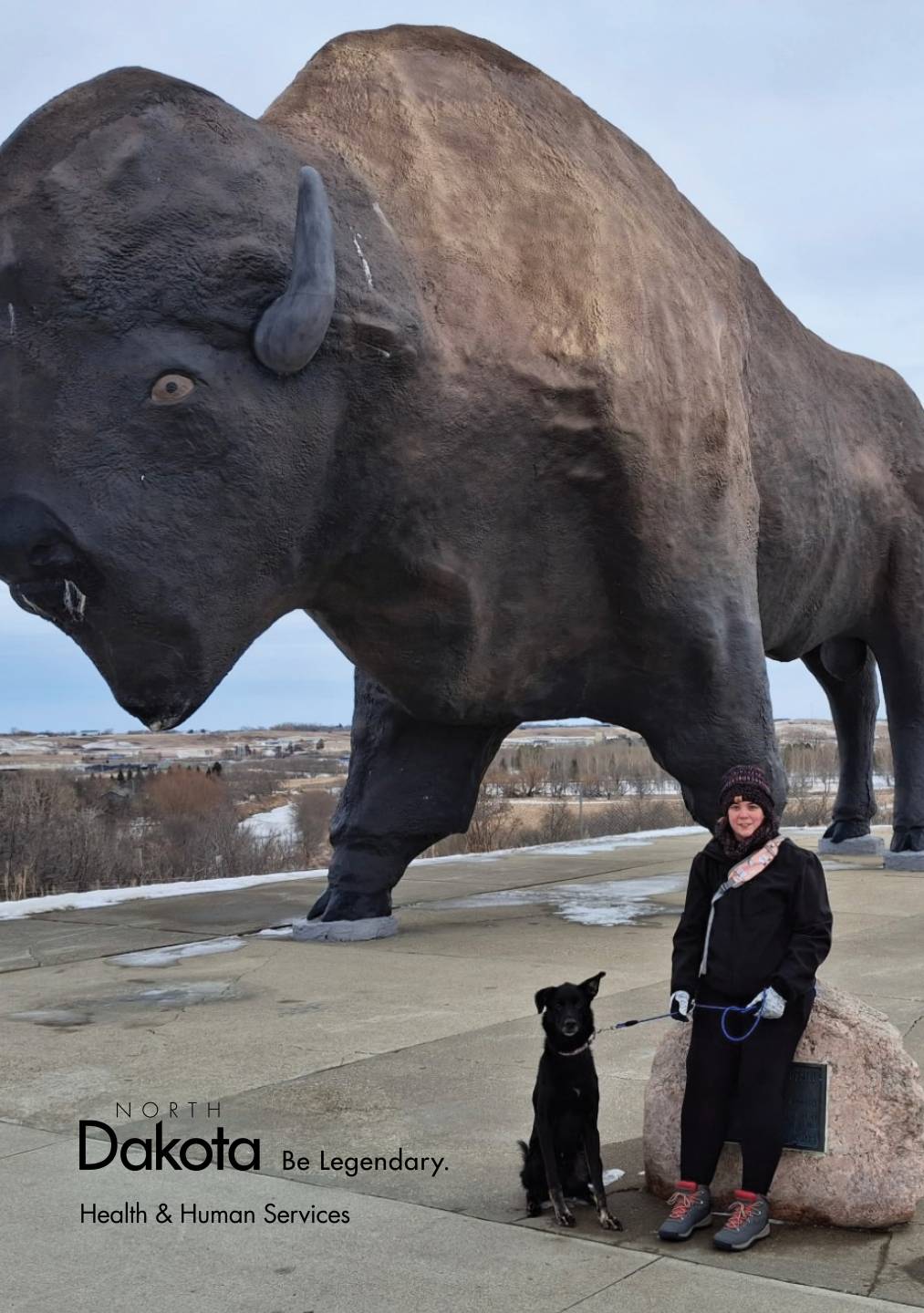 Dori Kinzler standing in front of buffalo statue in Jamestown North Dakota