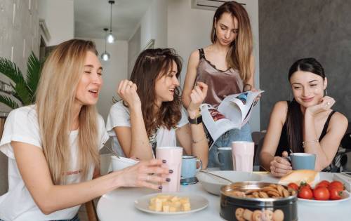 women eating snacks at kitchen table