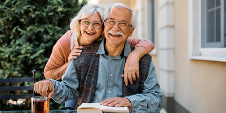 Smiling older couple on outside patio