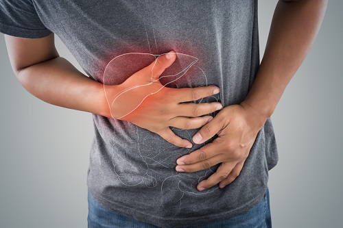 Young man clutching stomach in agony