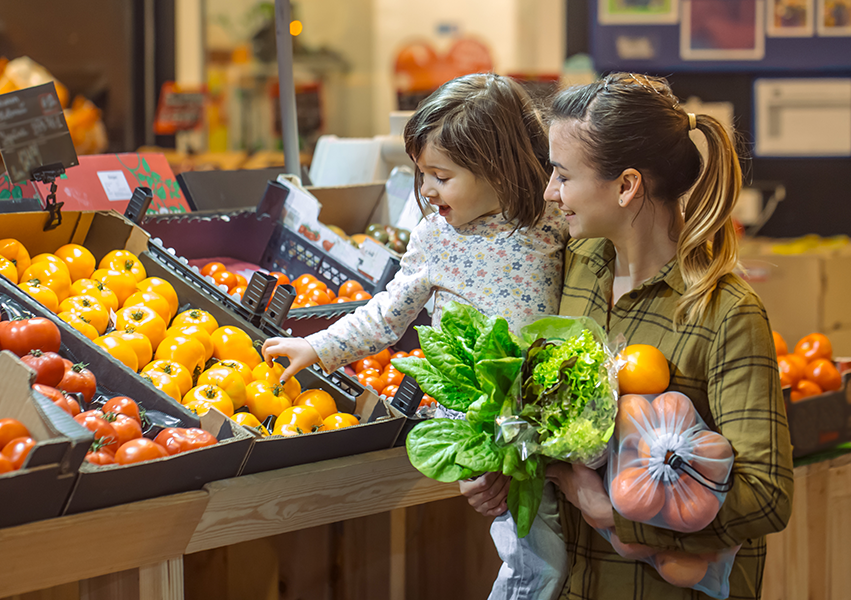 Mother and daughter shopping for produce