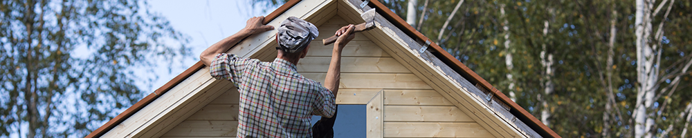 image of a man working on his house