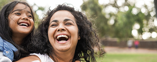 Mother and daughter smiling
