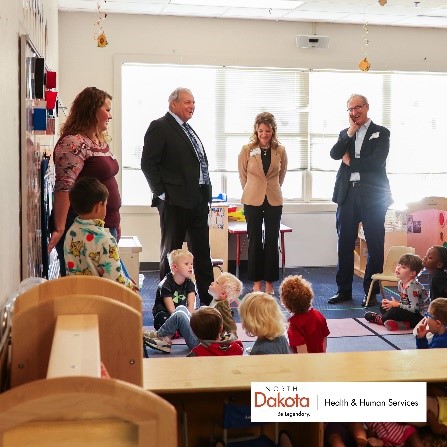 North Dakota state leaders with a group of children