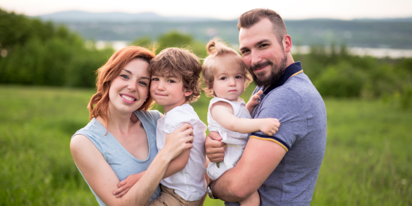 parents holding two toddlers