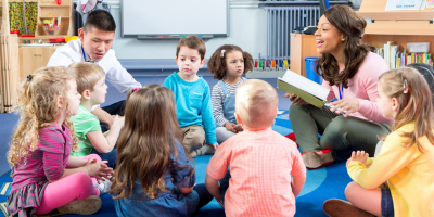 teachers reading to preschool children