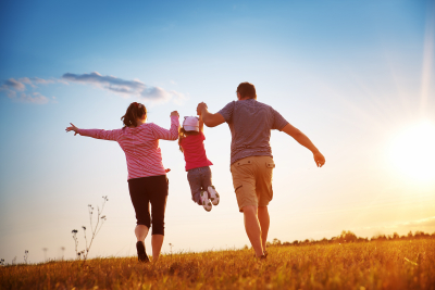 family plays in a field