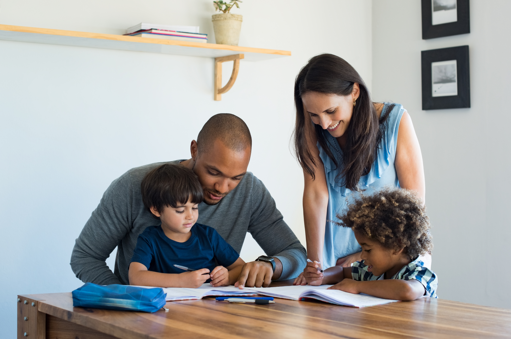 happy young family sit around a table