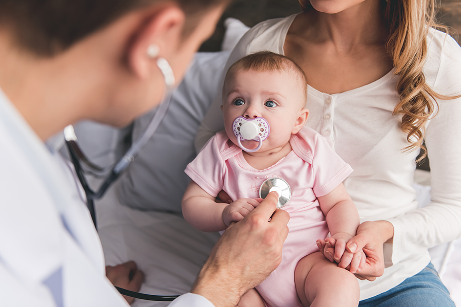 Baby getting a check up at the doctor