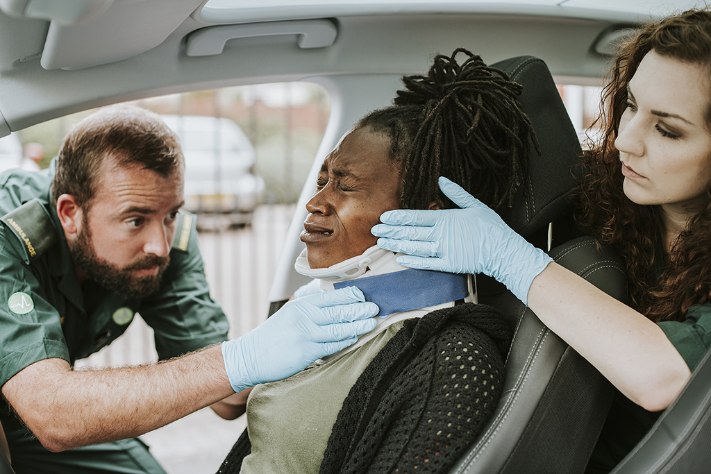 EMTs assist a woman following a collision