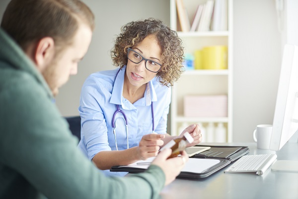 Health provider talking to male patient