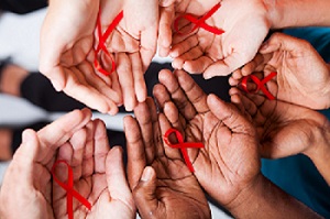AIDS awareness ribbons in hands
