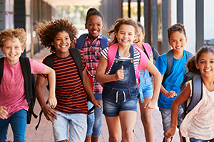 Children running in outdoor hallway