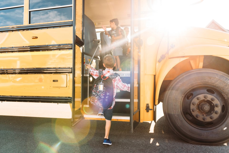 Boy boarding bus