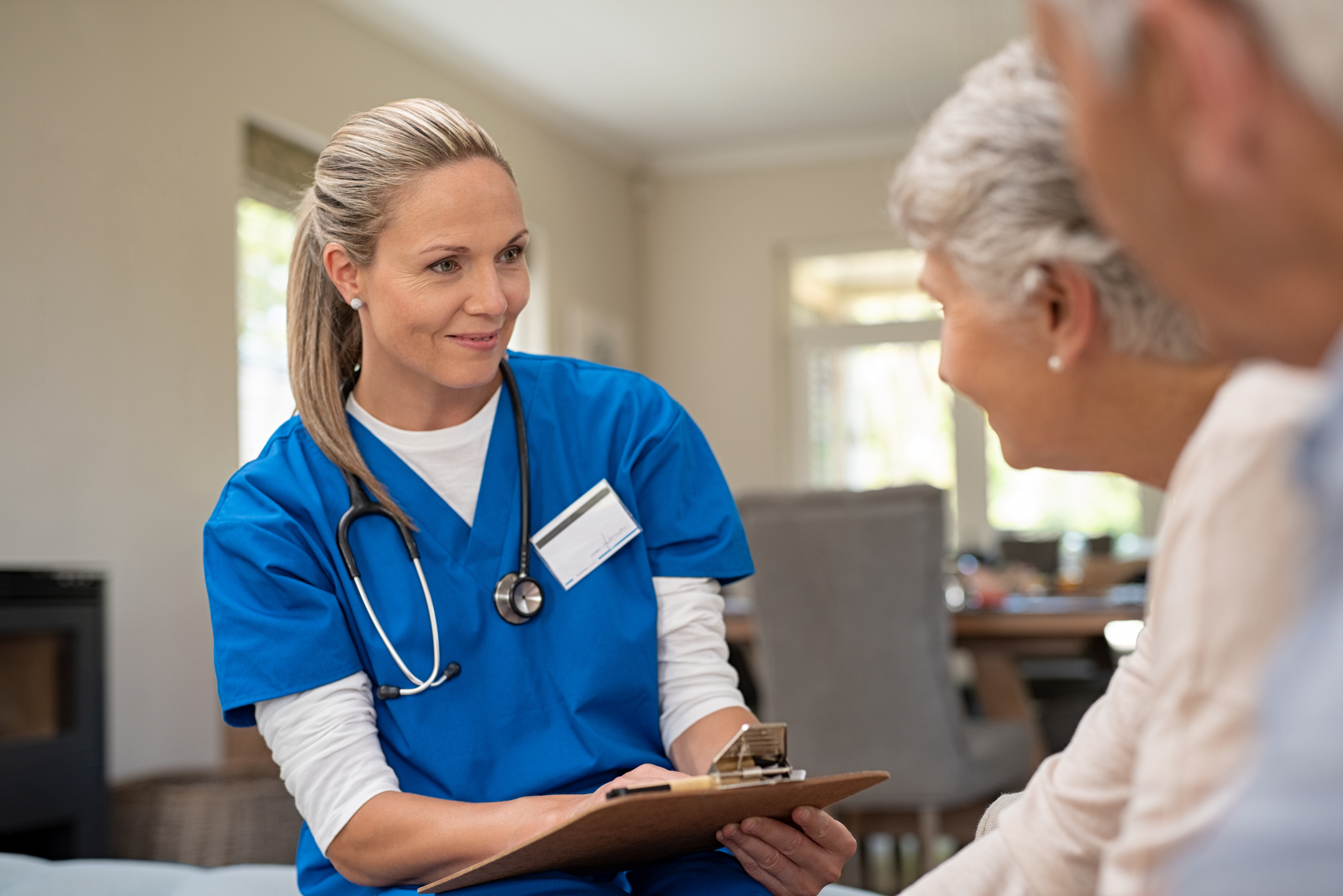 Nurse with clipboard and patient