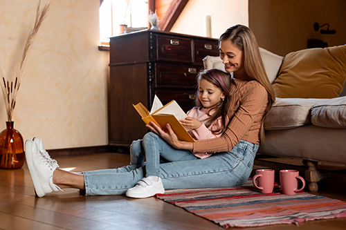 Image of a mother and child reading a book