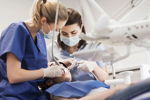 Two dental hygienists working