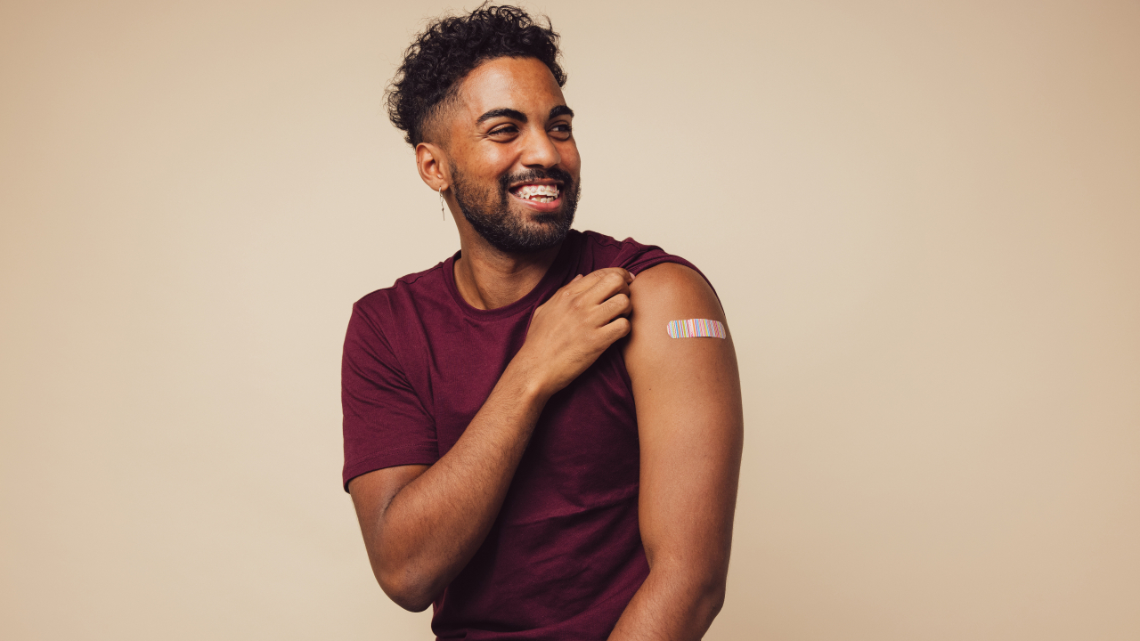 Man showing arm with bandaid
