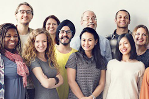 Group of people from all over smiling