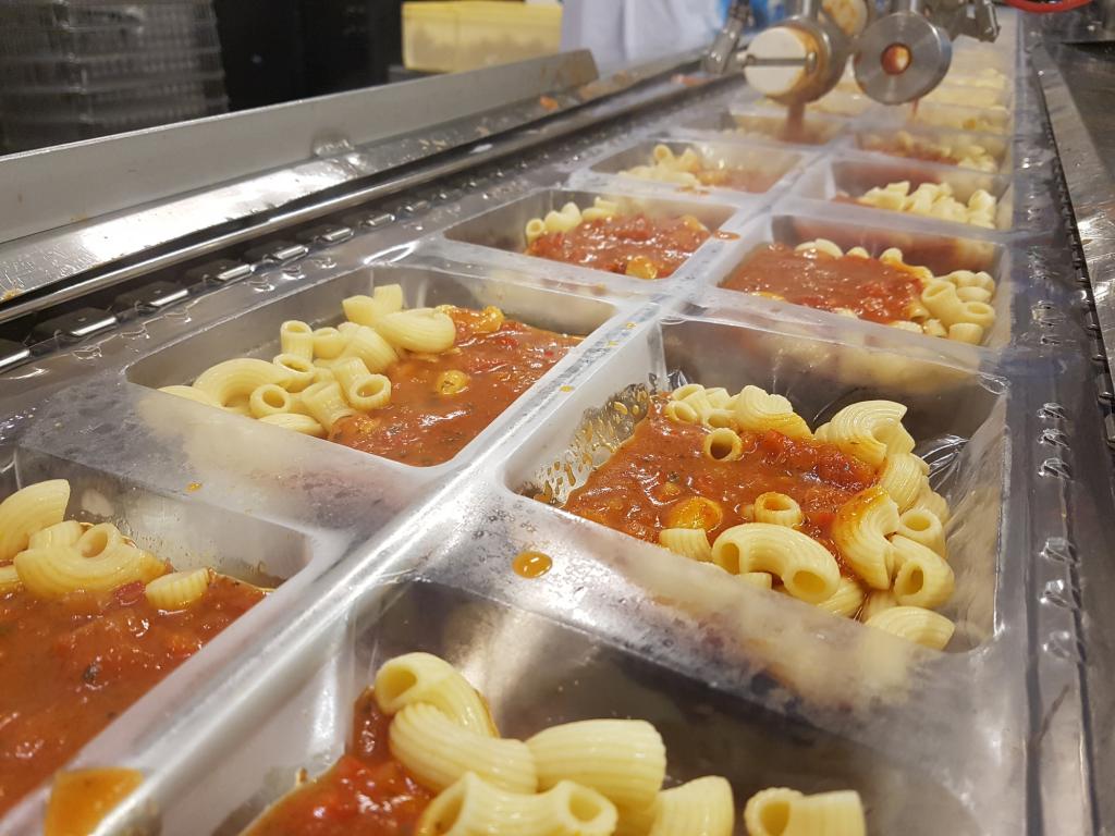 Prepared mac and cheese in food processing plant