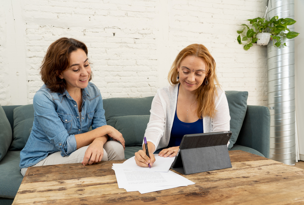 two women work on paperwork together