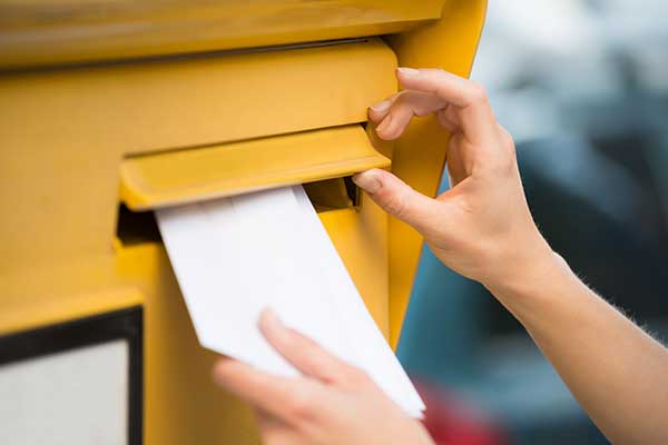 Letter being put in a maildrop 