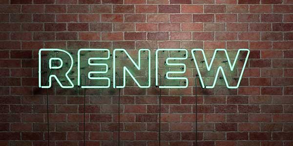 Lighted sign that says Renew on brick wall