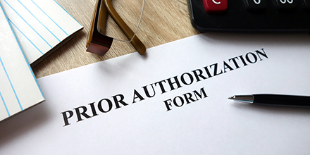 Notepad with text Prior Authorization form on it.