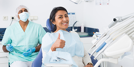 A girl smiling in a dental chair.