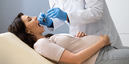 A pregnant woman getting her teeth clean