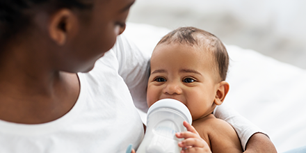 A woman bottle feeding her baby