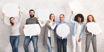 Various people holding blank signs shaped like speech bubbles and thought clouds.