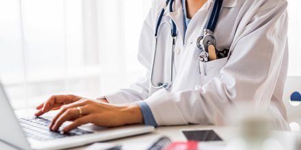 doctor working on a laptop